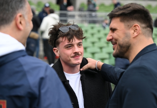  Music and rap artist Olly is seen watching on from the side of the pitch before the Guinness Six Nations 2026 match between Ireland and Italy at Aviva Stadium on February 14, 2026 in Dublin, Ireland. (Photo by Federugby/Federugby via Getty Images)