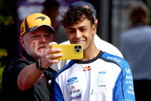  Arvid Lindblad of Great Britain and Visa Cash App Racing Bulls poses for a selfie with a fan in the Paddock prior to the F1 Grand Prix of Australia at Albert Park Grand Prix Circuit on March 08, 2026 in Melbourne, Australia. (Photo by Joe Portlock/Getty Images)