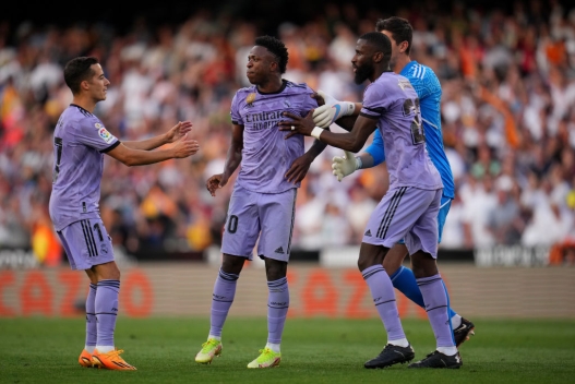  Lucas Vazquez, Thibaut Courtois and Antonio Ruediger of Real Madrid escort teammate Vinicius Junior off of the pitch after he is shown a red card during the LaLiga Santander match between Valencia CF and Real Madrid CF at Estadio Mestalla on May 21, 2023 in Valencia, Spain. (Photo by Aitor Alcalde/Getty Images)