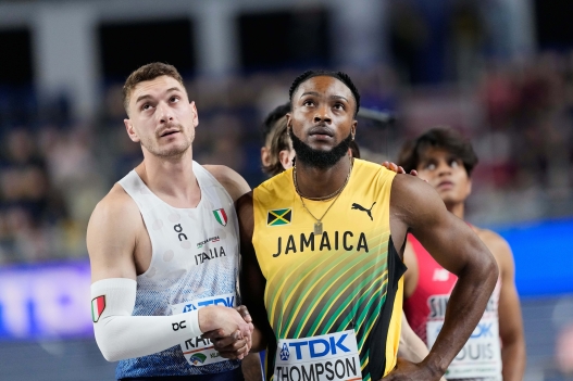 Kishane Thompson, of Jamaica, and Filippo Randazzo, of Italy, shake hands after crossing the finish line in a men's 60 meters heat at the World Athletics Indoor Championships in Torun, Poland, Friday, March 20, 2026. (AP Photo/Petr David Josek)      Associate Press/ LaPresse Only Italy and Spain