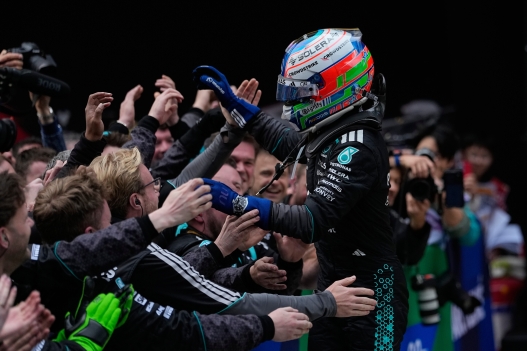 Mercedes driver Andrea Kimi Antonelli of Italy jumps to his team crew members to celebrate after winning the Chinese Formula One Grand Prix race at the Shanghai International Circuit, in Shanghai, China, Sunday, March 15, 2026. (AP Photo/Andy Wong)