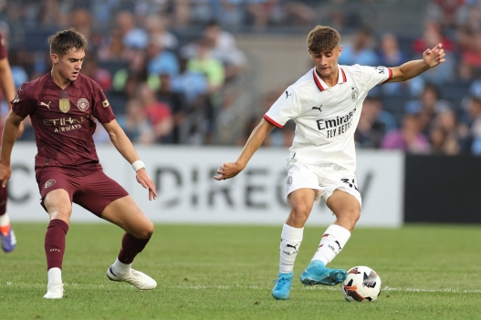 AC Milan's forward Mattia Liberali (R) controls the ball controls the ball during the pre-season club friendly football match between Manchester City and AC Milan at Yankee Stadium in New York on July 27, 2024. (Photo by Charly TRIBALLEAU / AFP)