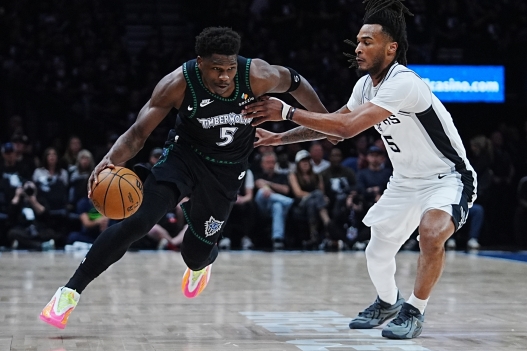 Minnesota Timberwolves guard Anthony Edwards, left, drives against San Antonio Spurs guard Stephon Castle, right, during the first half of Game 6 of an NBA basketball second-round playoffs series in Minneapolis, Friday, May 15, 2026. (AP Photo/Abbie Parr)