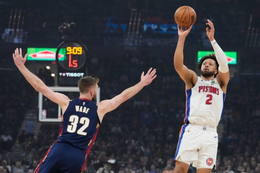 Detroit Pistons' Cade Cunningham (2) shoots over Cleveland Cavaliers' Dean Wade (32) in the first half of Game 6 of a second-round NBA basketball playoffs series Friday, May 15, 2026, in Cleveland. (AP Photo/Sue Ogrocki)