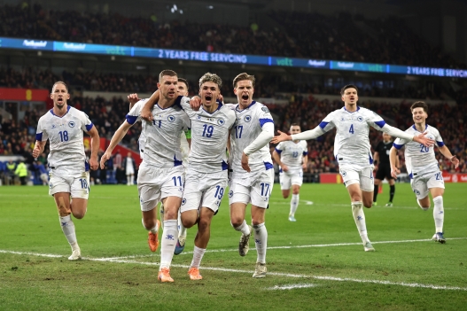 CARDIFF, WALES - MARCH 26: Edin Dzeko of Bosnia and Herzegovina celebrates scoring his team's first goal with teammates during the FIFA World Cup 2026 European Qualifiers KO play-off match between Wales and Bosnia and Herzegovina at Cardiff City Stadium on March 26, 2026 in Cardiff, Wales. (Photo by Warren Little/Getty Images)