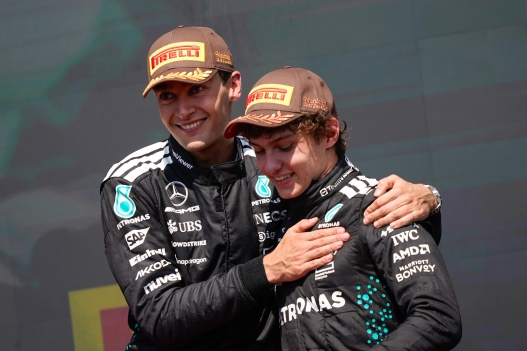 TOPSHOT - (L/R) Race winner Mercedes' British driver George Russell celebrates with teammate and third place finisher Mercedes' Italian driver Kimi Antonelli on the podium after the 2025 Formula 1 Grand Prix du Canada at Circuit Gilles-Villeneuve in Montreal, Canada, on June 15, 2025. (Photo by Geoff Robins / AFP)