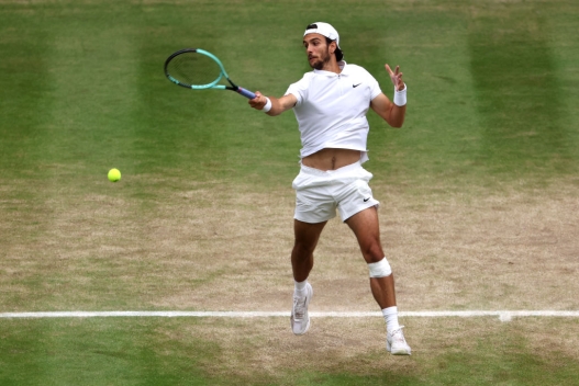 LONDON, ENGLAND - JULY 12: Lorenzo Musetti of Italy plays a forehand against Novak Djokovic of Serbia in the Gentlemen's Singles Semi-Final match during day twelve of The Championships Wimbledon 2024 at All England Lawn Tennis and Croquet Club on July 12, 2024 in London, England. (Photo by Francois Nel/Getty Images)