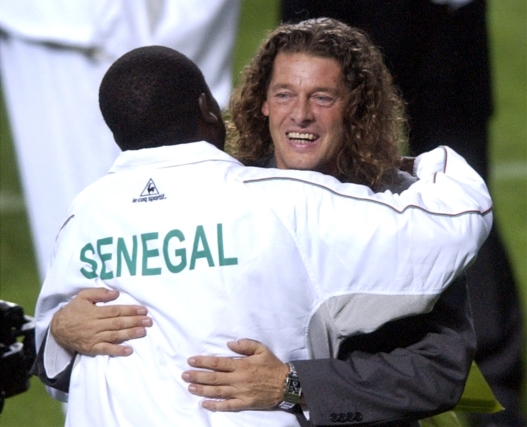 Senegal's national team coach Bruno Metsu, from France, right, hugs an unidentified team member, left, after Senegal defeated France 1-0 in  their Group A World Cup 2002 soccer game Friday, May 31, 2002 at the World Cup Stadium in Seoul, South Korea. Also in Group A are Denmark and Uruguay. (AP Photo/Elise Amendola)