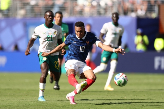 TOPSHOT - France's forward #10 Kylian Mbappe shoots to score his team's third goal during the 2026 World Cup Group I football match between France and Senegal at the New York/New Jersey Stadium in East Rutherford on June 16, 2026.  (Photo by CHARLY TRIBALLEAU / AFP)