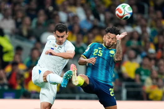 Uzbekistan's Rustam Ashurmatov and Colombia's Luis Suarez, right, battle for the ball during the World Cup Group K soccer match between Uzbekistan and Colombia in Mexico City, Wednesday, June 17, 2026. (AP Photo/Natacha Pisarenko)