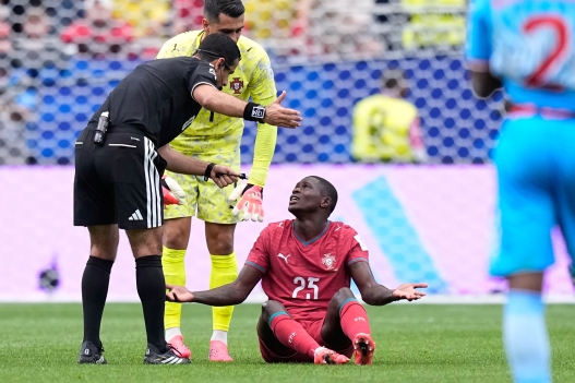 Portugal's Nuno Mendes gestures to Referee Abdulrahman Al-Jassim, of Qatar, during the World Cup Group K soccer match between Portugal and Congo in Houston, Wednesday, June 17, 2026. (AP Photo/Ashley Landis)