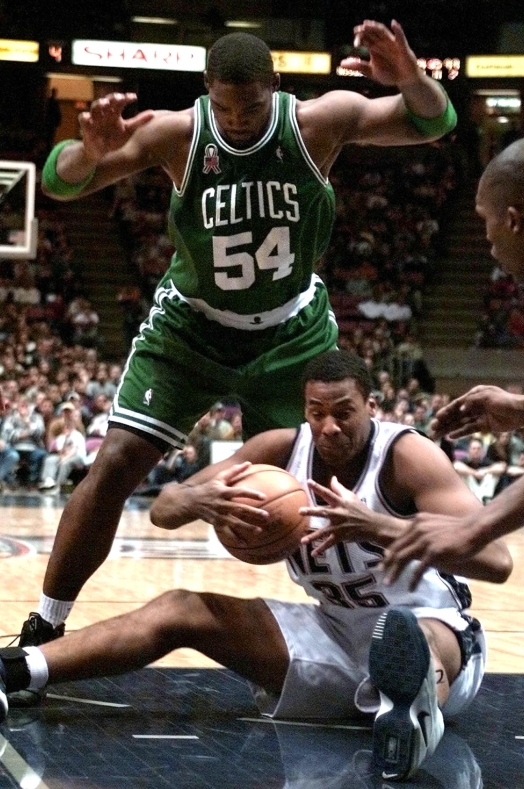 Boston Celtics forward Rodney Rogers (top) covers New Jersey Nets center Jason Collins (bottom) as he tries to control a loose ball in the third quarter 07 April, 2002 at Continental Airlines Arena in East Rutherford, NJ. The Celtics beat the Nets 102-90.   AFP PHOTO/Matt CAMPBELL (Photo by AFP)