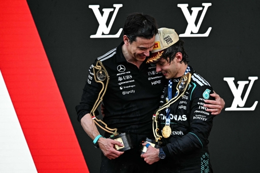 Winner Mercedes' Italian driver Kimi Antonelli (R) celebrates with Mercedes' Austrian team principal and CEO Toto Wolff, who won the constructor trophy, on the podium after competing in Monaco Formula 1 Grand Prix at the Monaco street circuit in Monaco, ahead of the, on June 7, 2026. (Photo by Gabriel BOUYS / AFP)