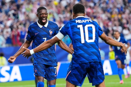 France's Ousmane Dembele (7) congratulates teammate Kylian Mbappe (10) after he scored their second goal during the World Cup Group I soccer match between France and Iraq in Philadelphia, Monday, June 22, 2026. (AP Photo/Petr David Josek)