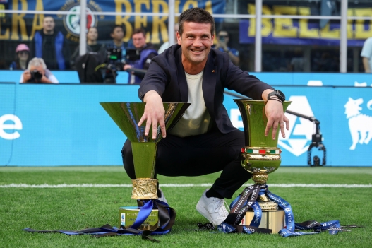FC Inter's coach Cristian Chivu  poses with the trophies for FC Inter's 21st championship and 10th Coppa Italia, after the Italian Serie A soccer match between FC Inter and Hellas Verona FC at Giuseppe Meazza Stadium in Milan, Italy, 17 May 2026. ANSA / ROBERTO BREGANI