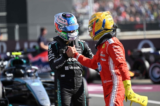 Mercedes' Italian driver Kimi Antonelli (L) congratulates Ferrari's British driver Lewis Hamilton (R) on his pole position after the sprint qualifying session ahead of the Formula One British Grand Prix at the Silverstone motor racing circuit in Silverstone, central England, on July 3, 2026. (Photo by PETER POWELL / POOL / AFP)