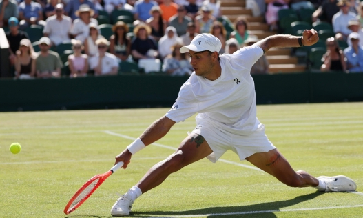 Italy's Flavio Cobolli returns to Russia's Karen Khachanov during their men's singles third round tennis match on the sixth day of the 2026 Wimbledon Championships at The All England Lawn Tennis and Croquet Club in Wimbledon, southwest London, on July 4, 2026. (Photo by Adrian DENNIS / AFP) / RESTRICTED TO EDITORIAL USE