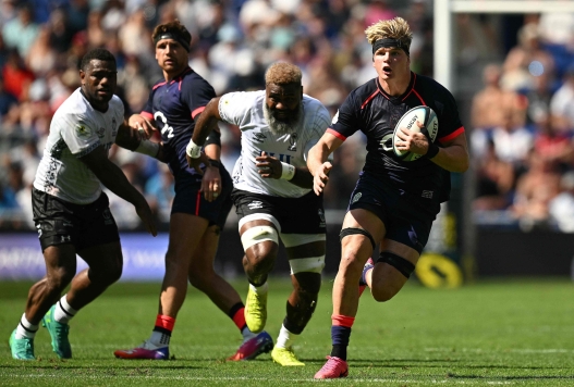 England's Henry Pollock runs with the ball during the Rugby Union Nations Championship match between Fiji and England at Hill Dickinson Stadium in Liverpool on July 11, 2026. (Photo by Oli SCARFF / AFP)