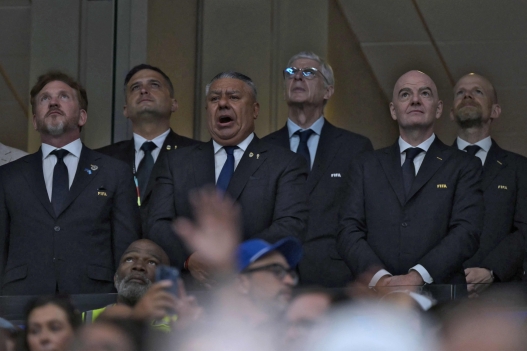 FIFA President Gianni Infantino (2R), President of CONMEBOL Alejandro Dominguez (L), FIFA's Chief of Global Football Development Arsene Wenger (CR) and Brazilian Fifa Deputy Secretary general Mattias Grafstrom (R) stand for the national anthems ahead of the 2026 World Cup football tournament semi-final match between England and Argentina at the Atlanta Stadium in Atlanta on July 15, 2026. (Photo by JUAN MABROMATA / AFP)