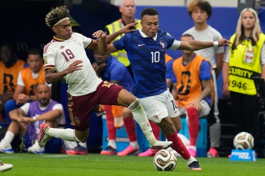 Spain's Lamine Yamal (19) stops France's Kylian Mbappe (10) during the World Cup semifinal soccer match between France and Spain in Arlington, Texas, near Dallas, Tuesday, July 14, 2026. (AP Photo/Tony Gutierrez)