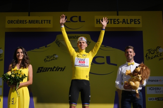 Slovenia's Tadej Pogacar, wearing the overall leader's yellow jersey celebrates on the podium after the eighteenth stage of the Tour de France cycling race, with start in Voiron and finish in Orcieres-Merlette, France, Thursday, July 23, 2026. (AP Photo/Thibault Camus)     Associated Press / LaPresse Only italy and spain