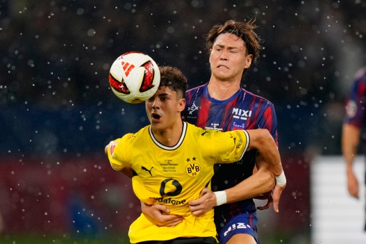 Borussia Dortmund's Samuele Inacio battles for the ball with FC Tokyo's Kento Hashimoto during a friendly soccer match between FC Tokyo and Borussia Dortmund in Tokyo, Saturday, Aug. 1, 2026. (AP Photo/Eugene Hoshiko)