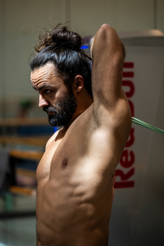 Catalin Preda of Romania stretches at the athletes area in the Copenhagen Opera House during the second competition day of the third stop of the Red Bull Cliff Diving World Series in Copenhagen, Denmark on June 26, 2026. // Dean Treml / Red Bull Content Pool // SI202606260435 // Usage for editorial use only //