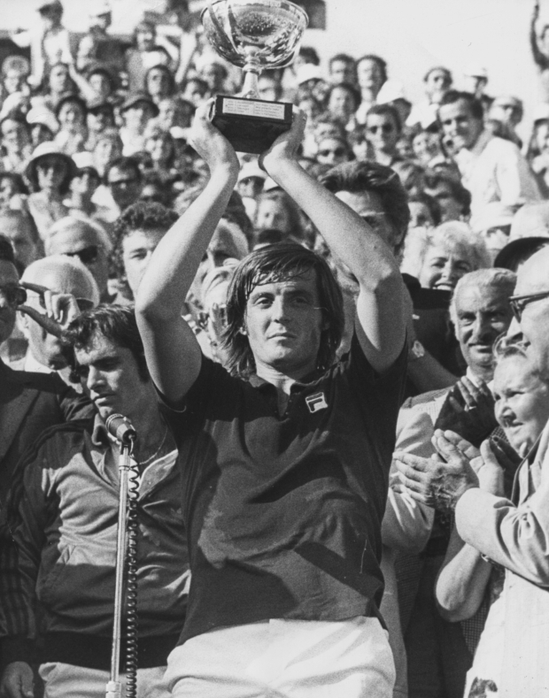 Italian tennis player Adriano Panatta holding his trophy in the air after winning the French Open Tennis Championships at Roland Garros, Paris, 1976. (Photo by Keystone/Hulton Archive/Getty Images)