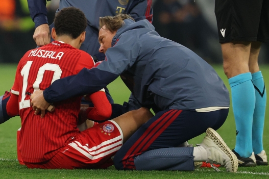 (FILES) Bayern Munich's German midfielder #10 Jamal Musiala receives medical attention during the UEFA Champions League second-leg, semi-final football match between FC Bayern Munich and Paris Saint-Germain (PSG) in Munich, southern Germany on May 6, 2026. Bayern Munich midfielder Jamal Musiala was taken off the pitch after collapsing in a pre-season friendly on August 18, 2026, three days after a similar incident in Munich. (Photo by Odd ANDERSEN / AFP)