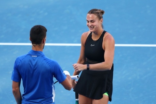  Aryna Sabalenka of Belarus (R) embraces Novak Djokovic of Serbia during A Night with Novak & Friends at Rod Laver Arena ahead of the 2024 Australian Open at Melbourne Park on January 11, 2024 in Melbourne, Australia. (Photo by Graham Denholm/Getty Images)