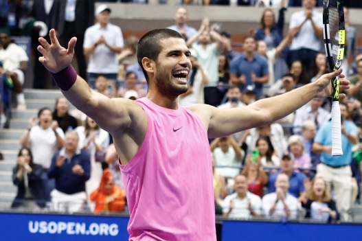 (FILES) Spains Carlos Alcaraz celebrates after defeating Italys Jannik Sinner during their men's singles final tennis match on day fifteen of the US Open tennis tournament at the USTA Billie Jean King National Tennis Center in New York City, on September 7, 2025. Carlos Alcaraz announced on August 20, 2026 that he will return at the US Open to defend his title after recovering from a wrist injury that has sidelined him for the past four months. (Photo by kena betancur / AFP)