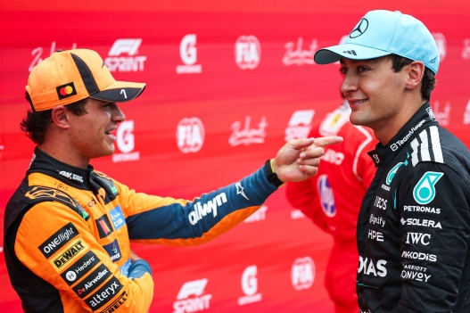 P2 McLaren's British driver Lando Norris (L) speaks with P1 Mercedes' British driver George Russell after the sprint race ahead of the Formula One Dutch Grand Prix at The Circuit Zandvoort, western Netherlands, on August 22, 2026. (Photo by SIMON WOHLFAHRT / AFP)