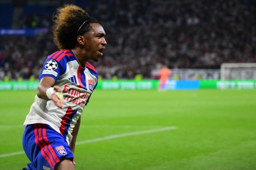 Lyon's Belgian forward #11 Malick Fofana celebrates after scoring Lyon's first goal during the UEFA Champions League qualifying playoff - second leg football match between Olympique Lyonnais (OL) and Fenerbahce SK and at the Groupama Stadium in Decines-Charpieu, central-eastern France, on August 26, 2026. (Photo by Olivier CHASSIGNOLE / AFP)