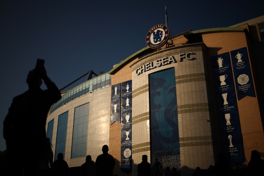 Supporters arrive to attend the English Premier League football match between Chelsea and Manchester United at Stamford Bridge in London on May 16, 2025. (Photo by HENRY NICHOLLS / AFP) / RESTRICTED TO EDITORIAL USE. No use with unauthorized audio, video, data, fixture lists, club/league logos or 'live' services. Online in-match use limited to 120 images. An additional 40 images may be used in extra time. No video emulation. Social media in-match use limited to 120 images. An additional 40 images may be used in extra time. No use in betting publications, games or single club/league/player publications. /