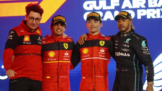 Winner Ferrari's Monegasque driver Charles Leclerc (2nd - R) celebrate on the podium with second place Ferrari's Spanish driver Carlos Sainz Jr ( 2nd - L)  and third placed Mercedes' British driver Lewis Hamilton (R)  and Ferrari team principal Mattia Binotto after the Bahrain Formula One Grand Prix at the Bahrain International Circuit in the city of Sakhir on March 20, 2022. (Photo by Giuseppe CACACE / AFP)