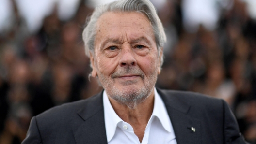 (FILES) French actor Alain Delon poses during a photocall before being awarded with an Honorary Palme d'Or at the 72nd edition of the Cannes Film Festival in Cannes, southern France, on May 19, 2019. Alain Delon's children filed a complaint on July 5, 2023, against the actor's companion for moral harassment and misappropriation of correspondence, their lawyer told AFP. (Photo by CHRISTOPHE SIMON / AFP)