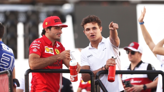 DOHA, QATAR - NOVEMBER 21: Lando Norris of Great Britain and McLaren F1 and Carlos Sainz of Spain and Ferrari talk on the drivers parade before the F1 Grand Prix of Qatar at Losail International Circuit on November 21, 2021 in Doha, Qatar. (Photo by Lars Baron/Getty Images)