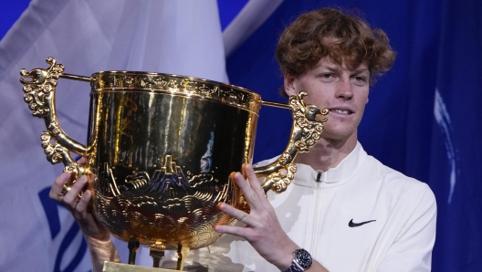 Jannik Sinner of Italy poses with his winning trophy on stage after defeating Daniil Medvedev of Russia in the men's singles final match of the China Open tennis tournament at the Diamond Court in Beijing, Wednesday, Oct. 4, 2023. (AP Photo/Andy Wong)