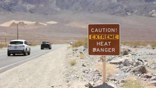 (FILES) A heat advisory sign is shown along US highway 190 during a heat wave in Death Valley National Park in Death Valley, California, on July 16, 2023. This year will be the hottest in recorded history after an "extraordinary" November became the sixth record-breaking month in row, Europe's climate monitor said on December 6, 2023, piling pressure on nations at the COP28 talks to act on climate change. Last month smashed the previous November heat record, pushing 2023's global average temperature to 1.46 degrees Celsius warmer than pre-industrial levels, the EU's Copernicus Climate Change Service said. (Photo by Ronda Churchill / AFP)