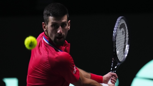 Serbia's Novak Djokovic plays a shot against Britain's Cameron Norrie during a Davis Cup quarter-final tennis match between Serbia and United Kingdom in Malaga, Spain, Thursday, Nov. 23, 2023. (AP Photo/Manu Fernandez)