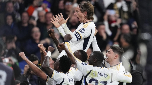 Real Madrid's Luka Modric celebrates with his teammates after scoring his team's first goal during a Spanish La Liga soccer match between Real Madrid and Sevilla at the Santiago Bernabeu stadium in Madrid, Spain, Sunday, Feb. 25, 2024. (AP Photo/Manu Fernandez)