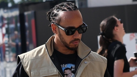 epa11174094 British Formula One driver Lewis Hamilton of Mercedes-AMG Petronas walks past the paddock during the pre-season testing for the 2024 Formula One season at the Bahrain International Circuit in Sakhir, Bahrain, 23 February 2024.  EPA/ALI HAIDER