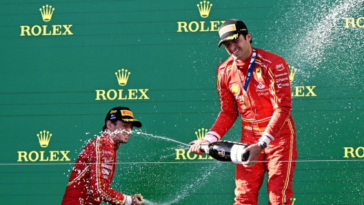 epa11240535 Ferrari's Charles Leclerc of Monaco (L) and Carlos Sainz of Spain celebrate second and first place respectively following the Australian Grand Prix 2024 at Albert Park Circuit in Melbourne, Australia 24 March 2024.  EPA/JOEL CARRETT AUSTRALIA AND NEW ZEALAND OUT