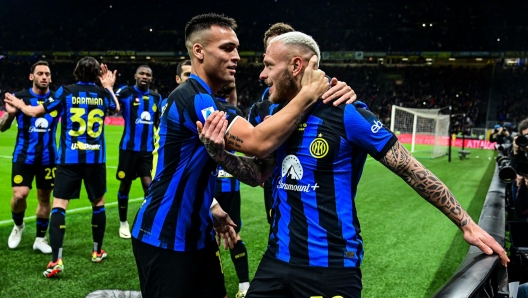 Inter Milan's Italian defender #32 Federico Dimarco (R) celebrates with Inter Milan's Argentine forward #10 Lautaro Martinez after scoring his team first goal during the Italian Serie A football match between Inter Milan and Empoli in Milan, on April 1, 2024. (Photo by Piero CRUCIATTI / AFP)