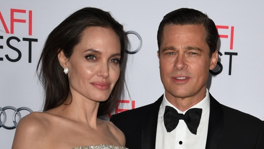 (FILES) This file photo taken on November 5, 2015 shows writer-director-producer-actress Angelina Jolie Pitt (L) and actor-producer Brad Pitt as they arrive for the opening night  premiere of Universal Pictures' 'By the Sea' at the TCL Chinese Theatre in Hollywood, California on November 5, 2015.        
US actress Angelina Jolie has filed for divorce from her husband Brad Pitt after two years of marriage and 12 years together, announced on September 20, 2016 by the website TMZ celebrity. / AFP PHOTO / MARK RALSTON