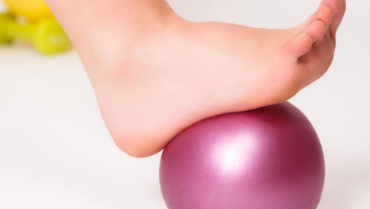 Closeup of a foot rolling on a ball