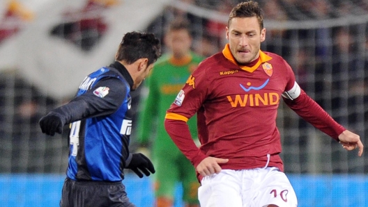 AS Roma's Francesco Totti (R) vies for the ball with FC Inter's Javier Zanetti during their Italian Cup semifinal soccer match at the Olimpico stadium in Rome, Italy, 23 January 2013.  ANSA/ETTORE FERRARI