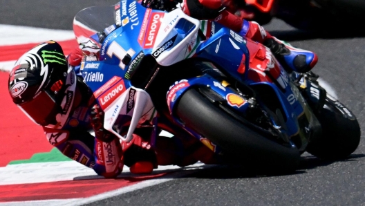 Ducati Italian rider Francesco Bagnaia (L) outpasses Ducati Spanish rider Jorge Martin during the Italian MotoGP race at Mugello on June 2, 2024. (Photo by Marco BERTORELLO / AFP)