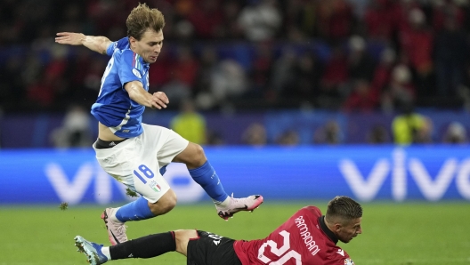 Italy's Nicolo Barella jumps over the challenge of Albania's Ylber Ramadani during the Group B match between Italy and Albania at the Euro 2024 soccer tournament in Dortmund, Germany, Saturday, June 15, 2024. (AP Photo/Martin Meissner)