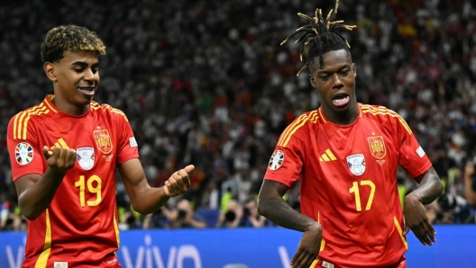 Spain's midfielder #17 Nico Williams celebrates with Spain's forward #19 Lamine Yamal after scoring his team's first goal during the UEFA Euro 2024 final football match between Spain and England at the Olympiastadion in Berlin on July 14, 2024. (Photo by INA FASSBENDER / AFP)